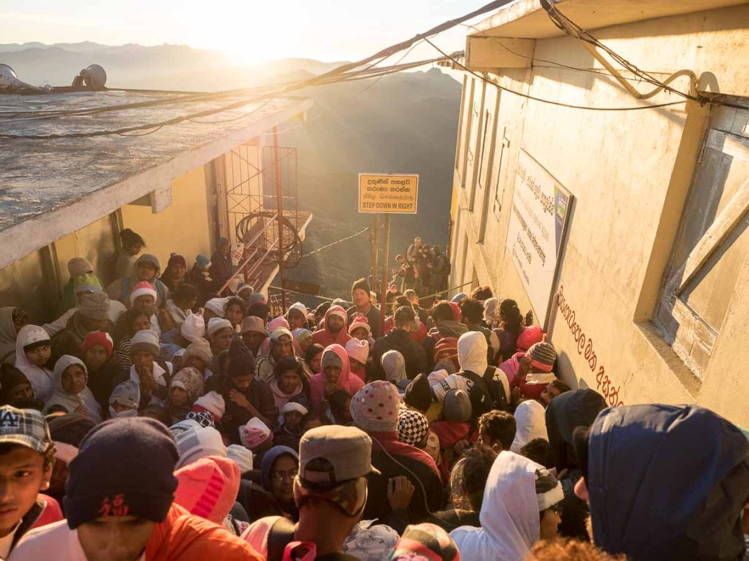 Tristan Balme crowsds at the top of adams peak