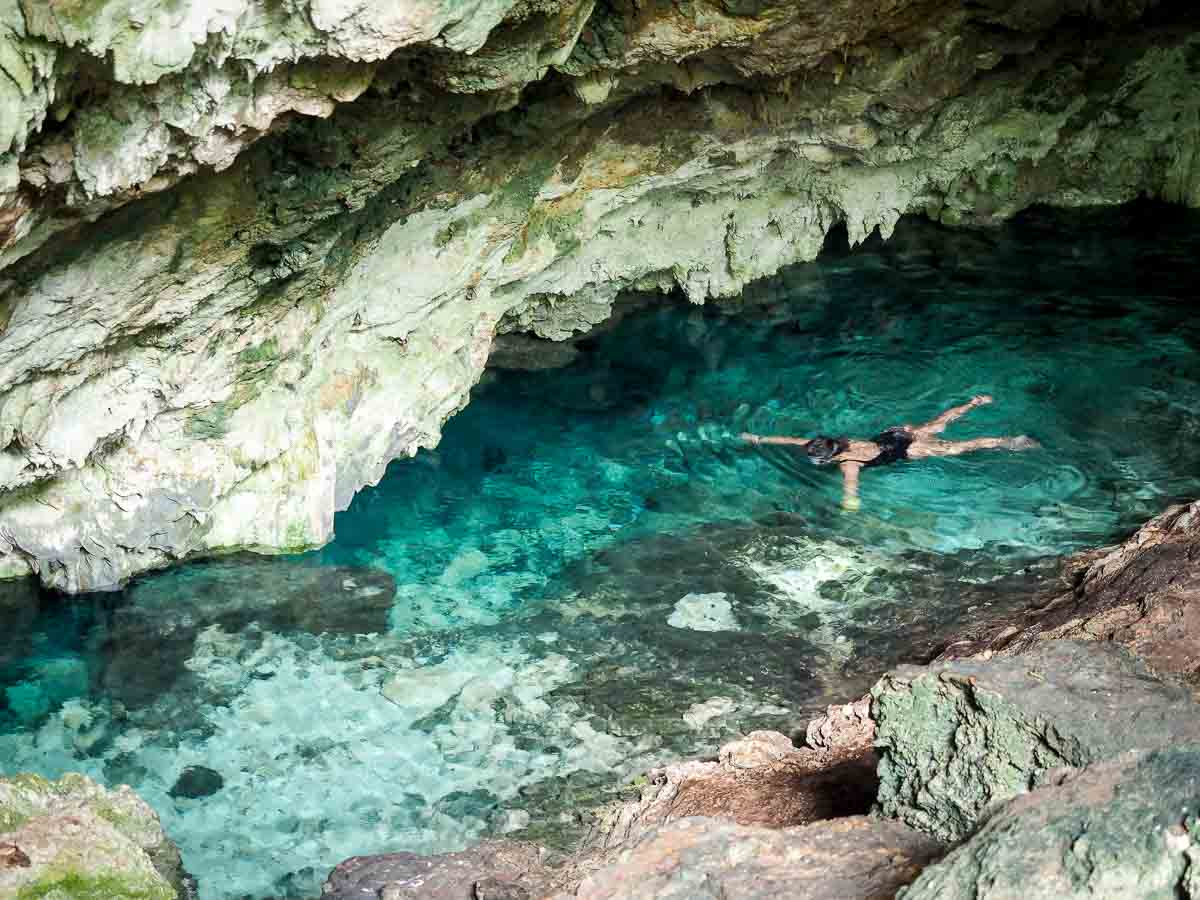 Swimming in the clear water inside Kuza Cave near Jambiani Zanzibar