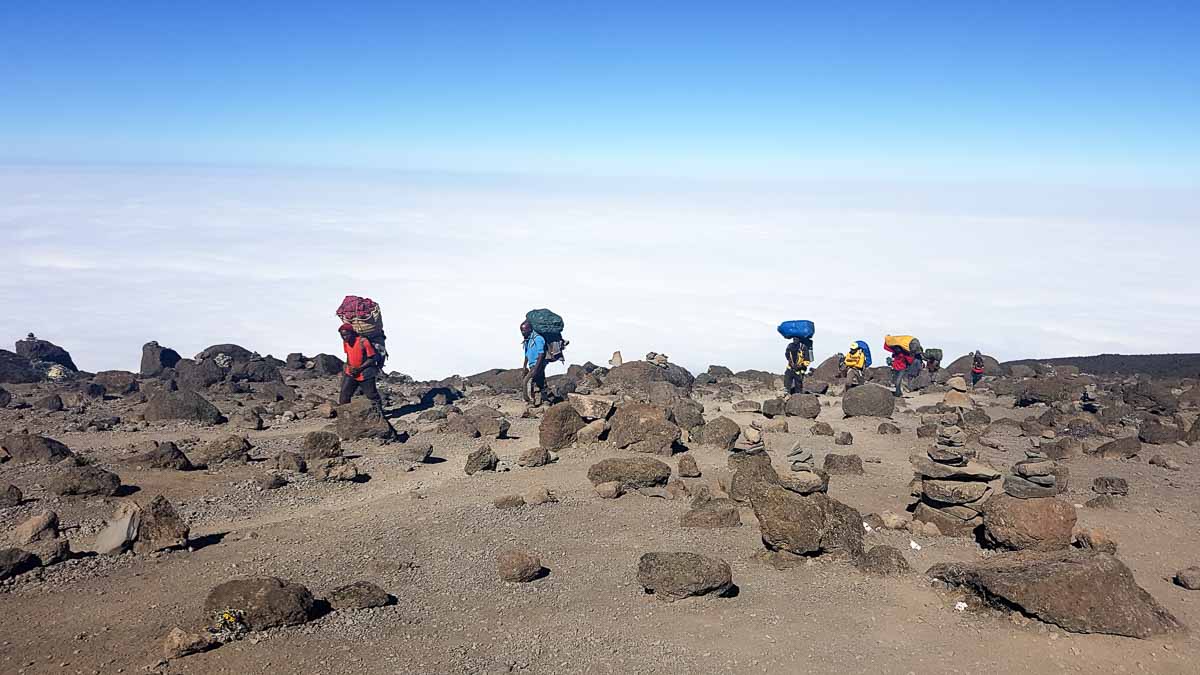 Tristan Balme porters trudging up kilimanjaro