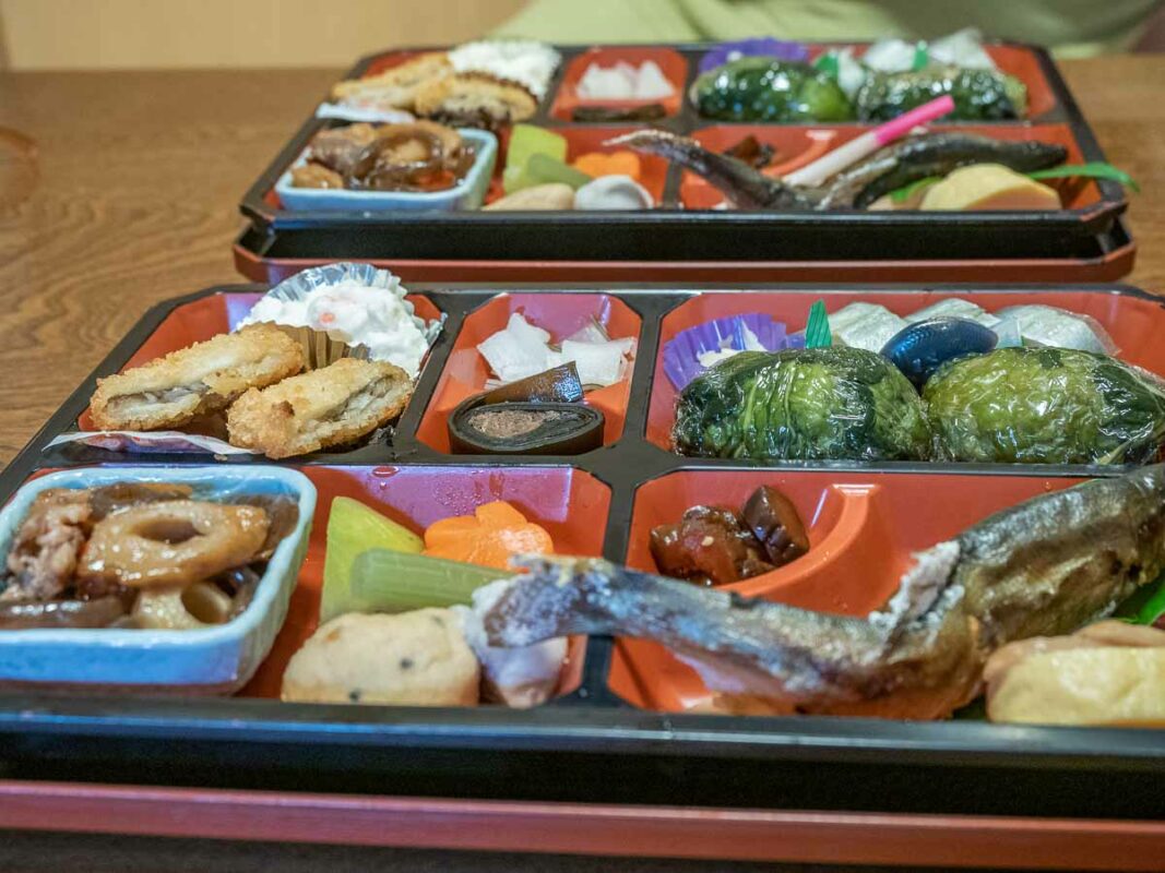 a image of two bento boxes showing two typical dinners in a japanese ryokan inn
