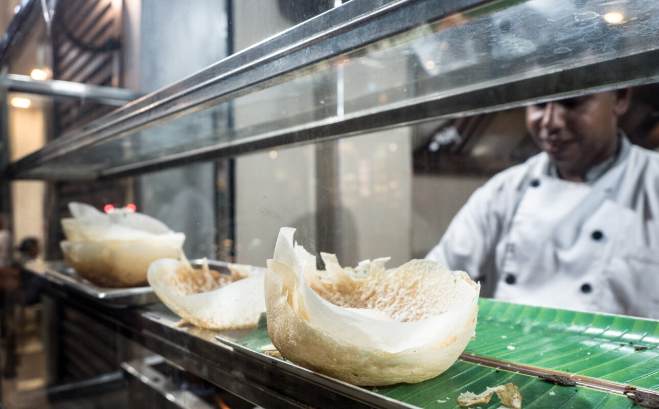 a chef in sri lanka making string hoppers