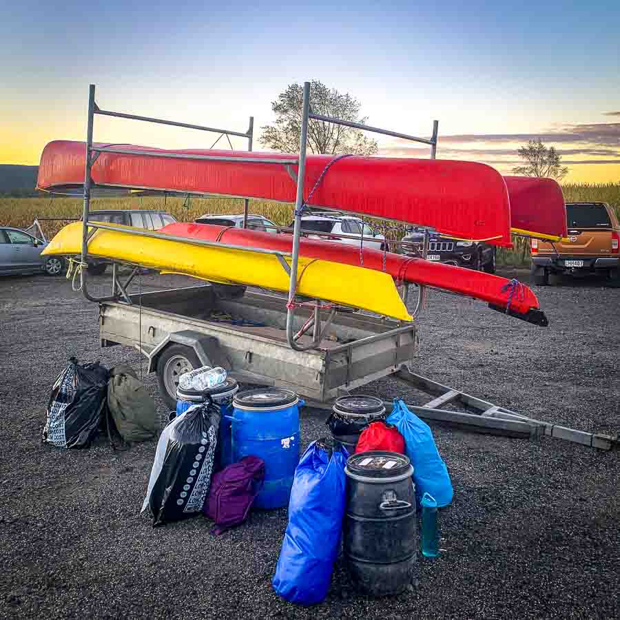 Canadian canoes and waterproof barrels ready for the Whanganui Journey