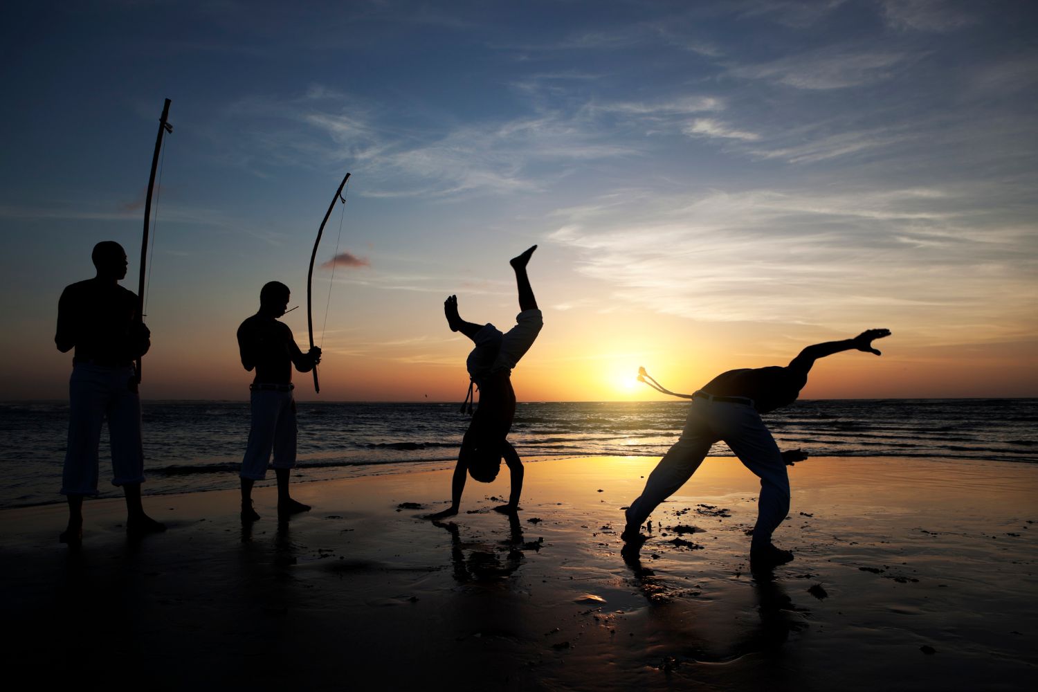 Local acrobats performing beside the Stone Town waterfront at sunset