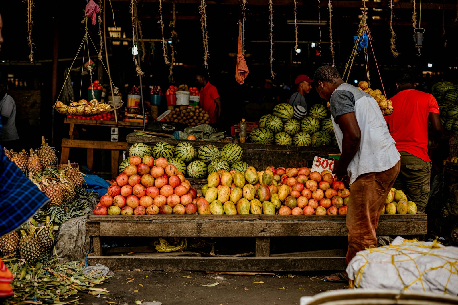 Tanzanian market produce stall with fresh fruits and vegetables - the working-day vibe at Mbuyuni Market in Moshi