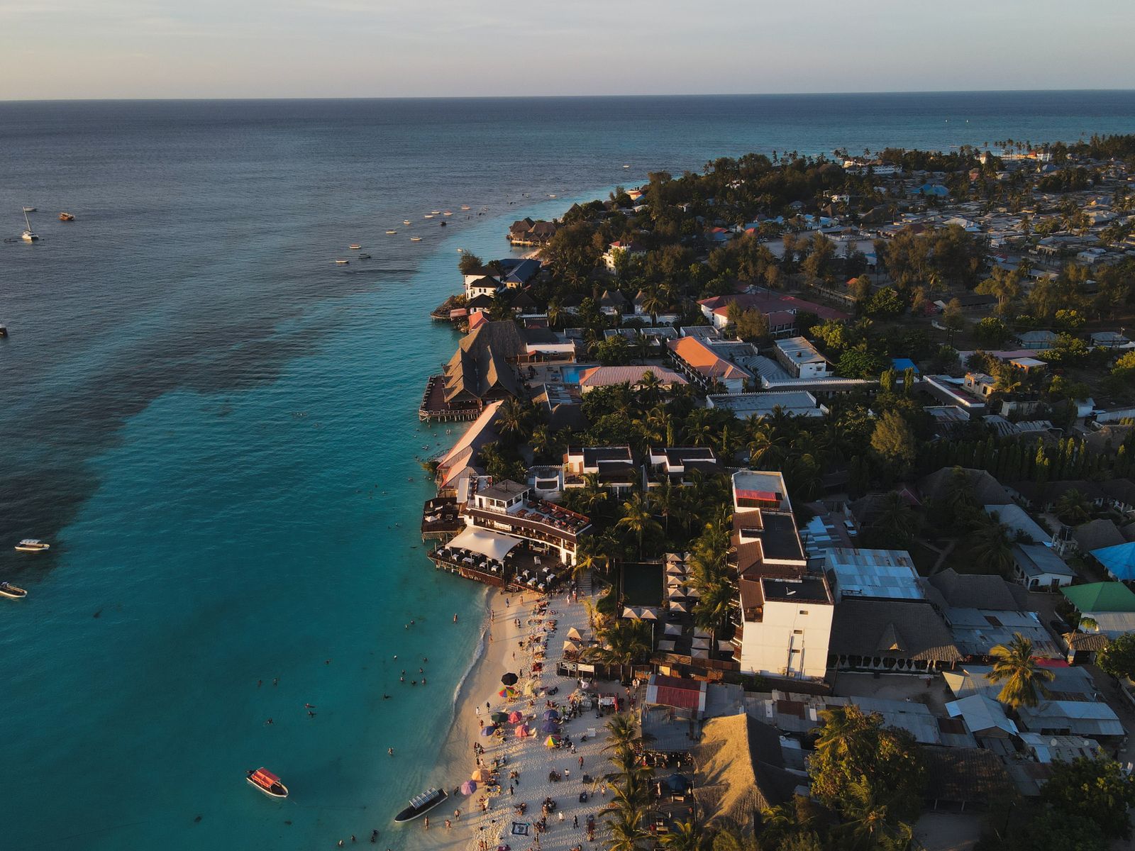 Aerial sunset view over Nungwi Beach and turquoise water in northern Zanzibar