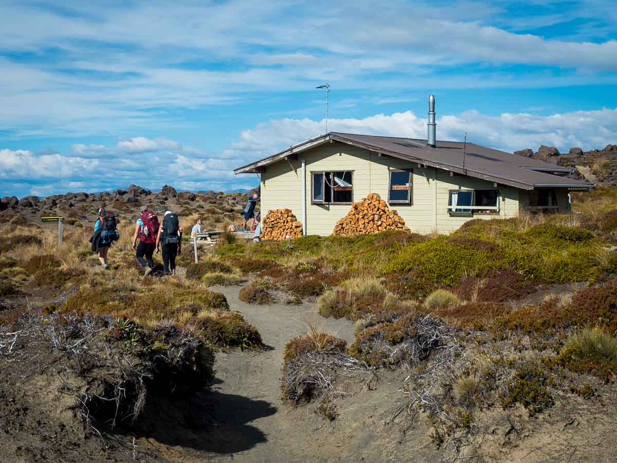 Trampers arriving at the former Oturere Hut on the Tongariro Northern Circuit