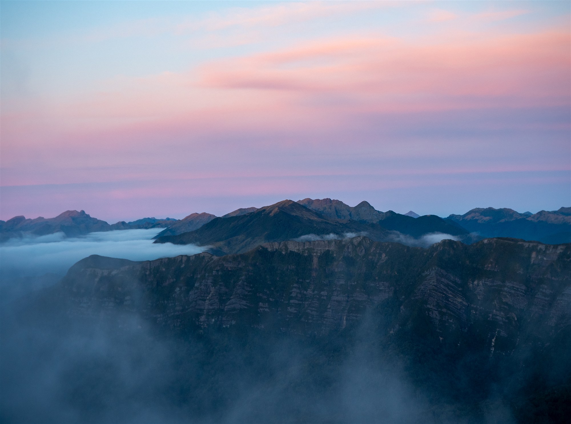 Pink sunset over the Paparoa Range from Moonlight Tops